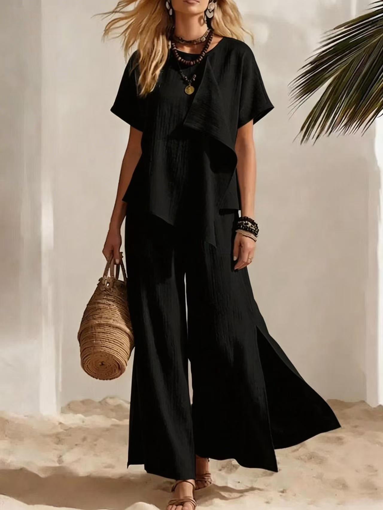 Woman in a black outfit holding a woven bag against a neutral background