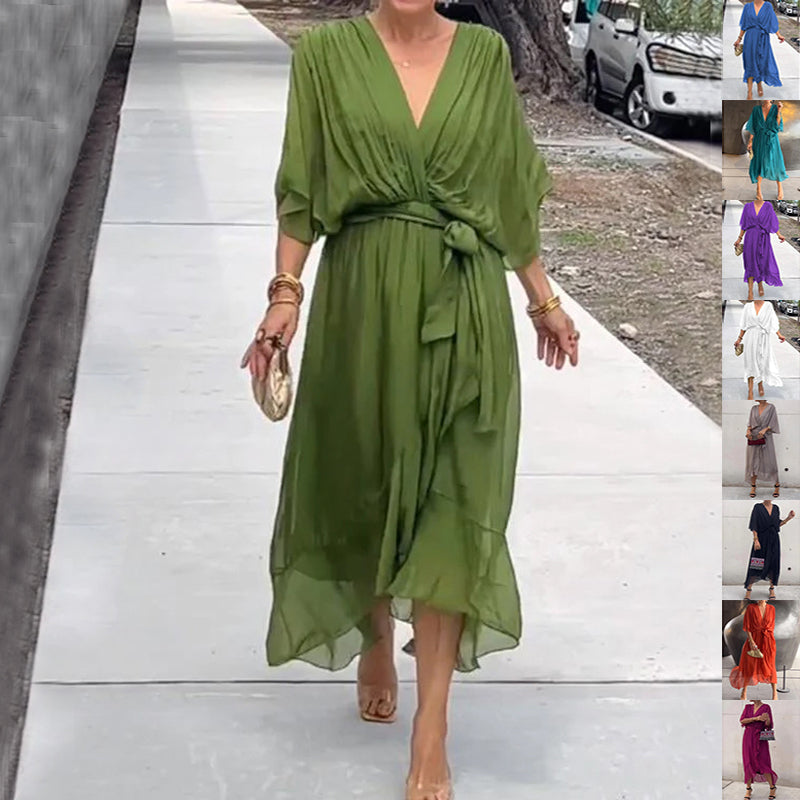 Woman wearing a green dress on a sidewalk with smaller images of the dress in various colors.