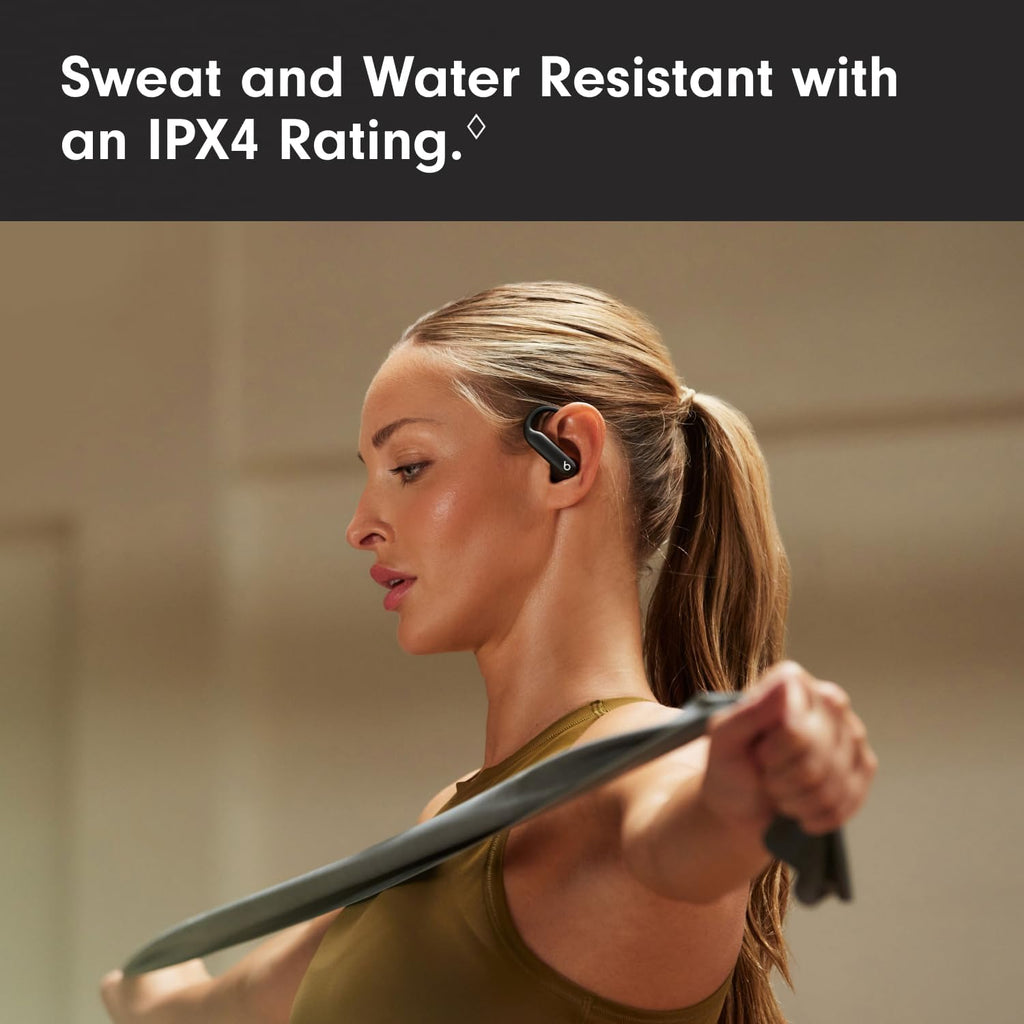 Woman exercising with resistance bands, wearing a sweat and water resistant device with an IPX4 rating.