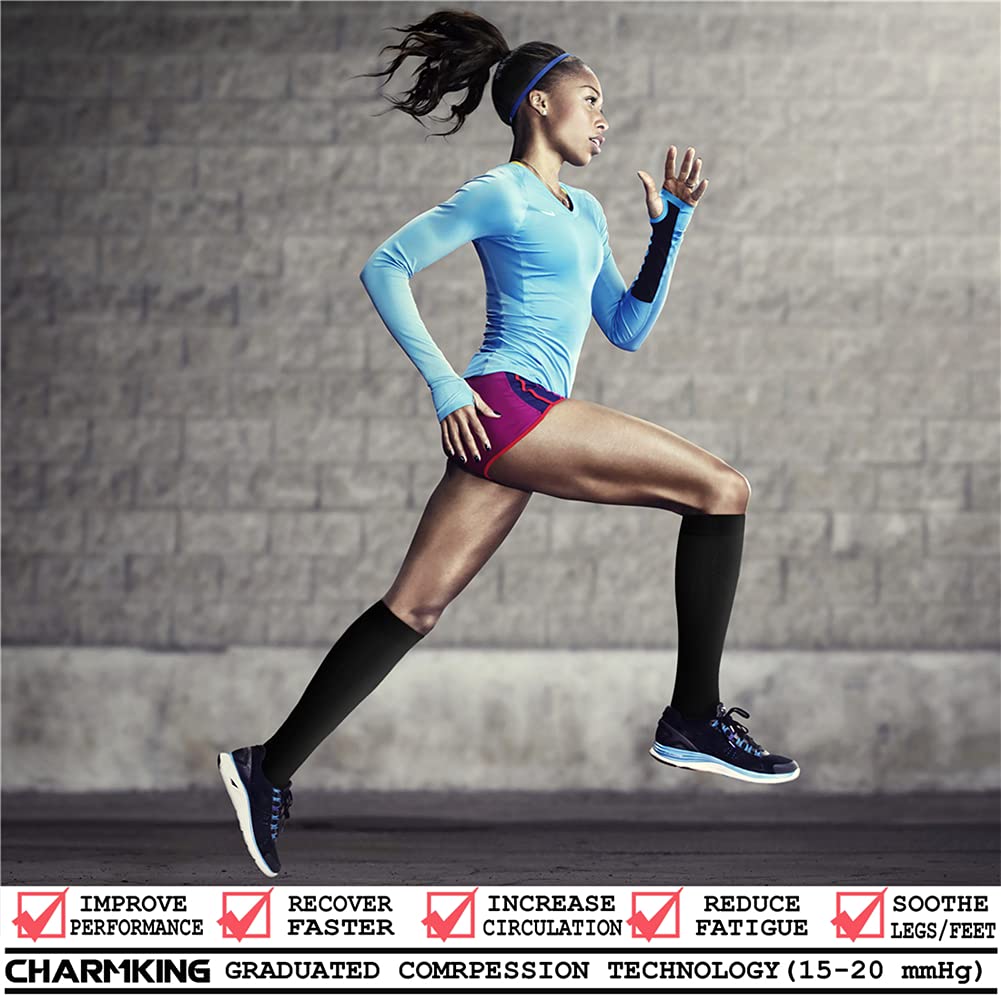 Woman running wearing Charmking graduated compression socks against a gray brick wall.