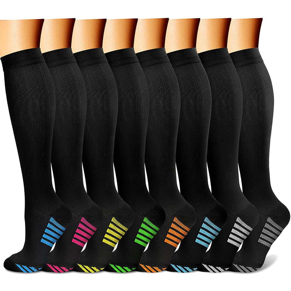 Multiple pairs of black knee-high socks with colorful striped patterns on a white background