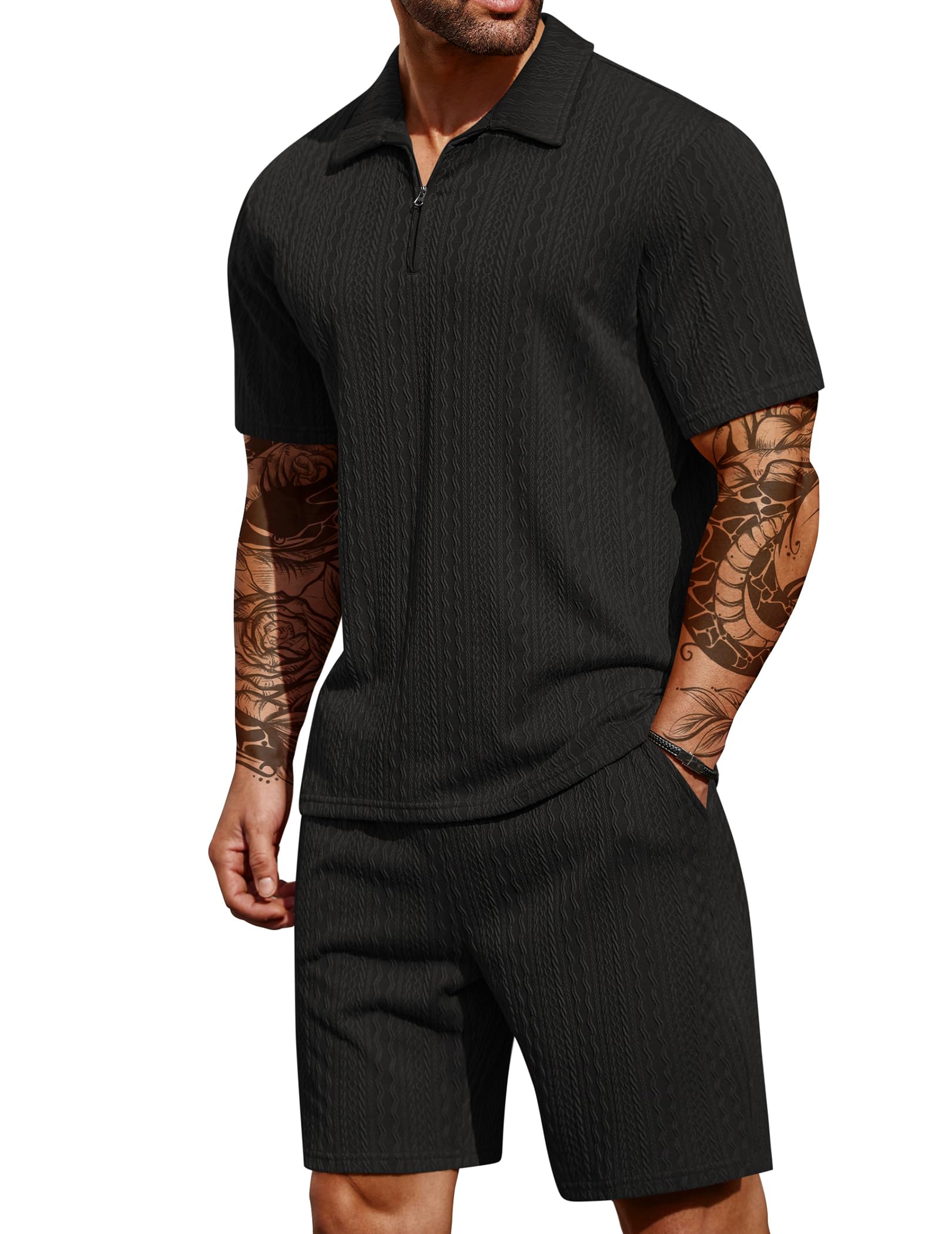 Man wearing a black ribbed polo shirt and shorts set on a white background
