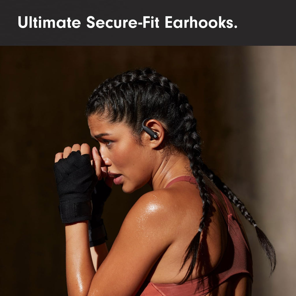 Woman wearing wireless earbuds with text 'Ultimate Secure-Fit Earhooks'.