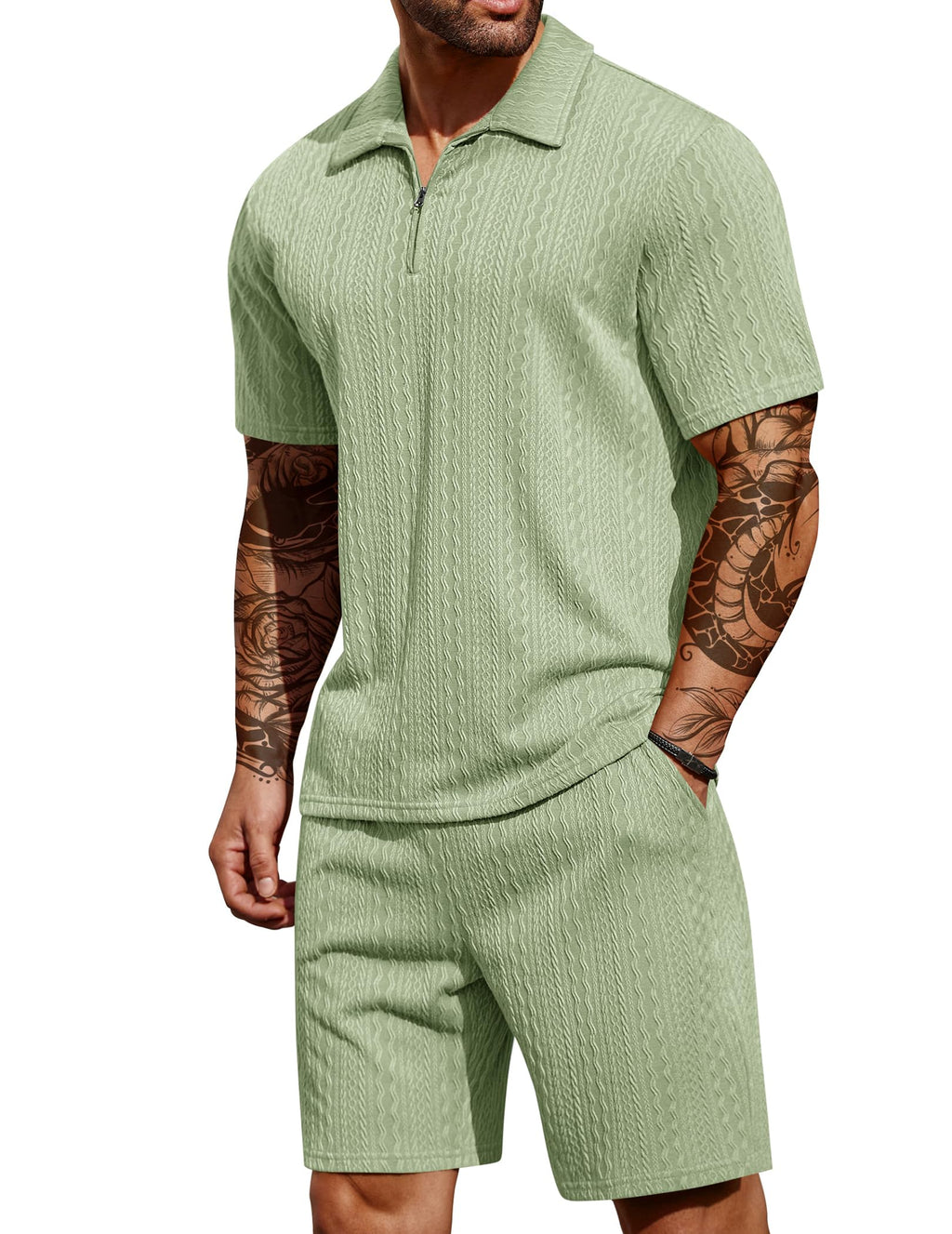 Man wearing a green textured polo shirt and shorts set on a white background