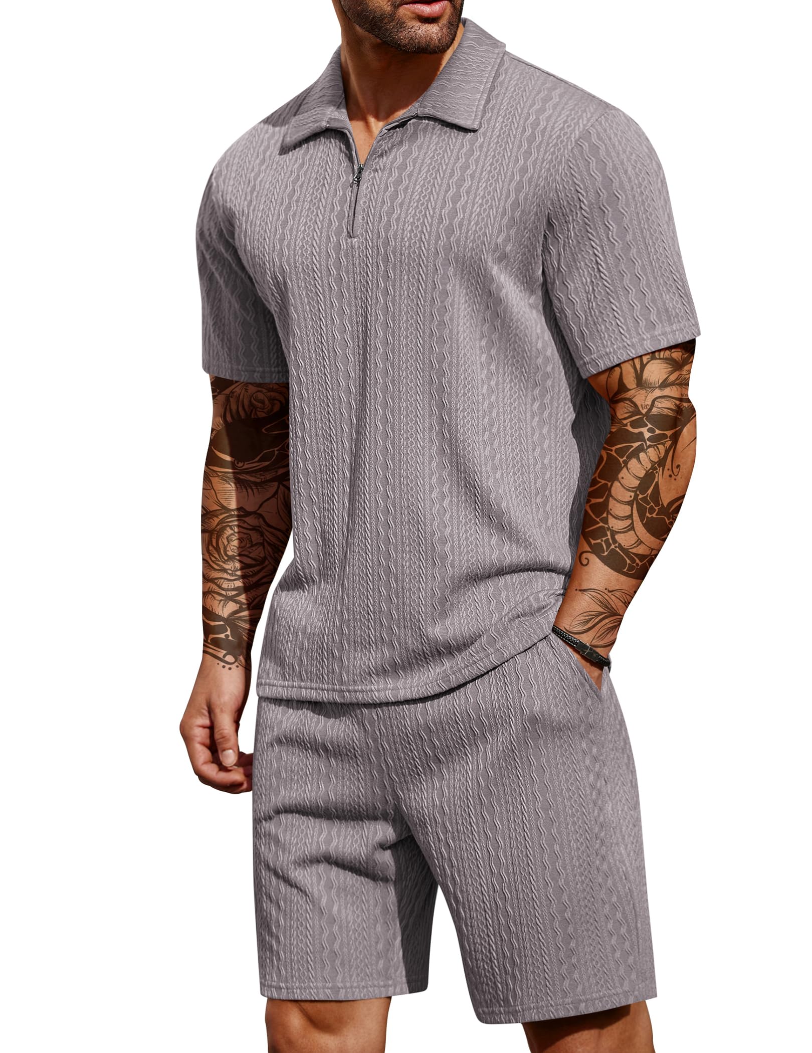 Man wearing a gray short-sleeve romper with a white background