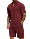 Man wearing a maroon ribbed polo shirt and shorts set on a white background