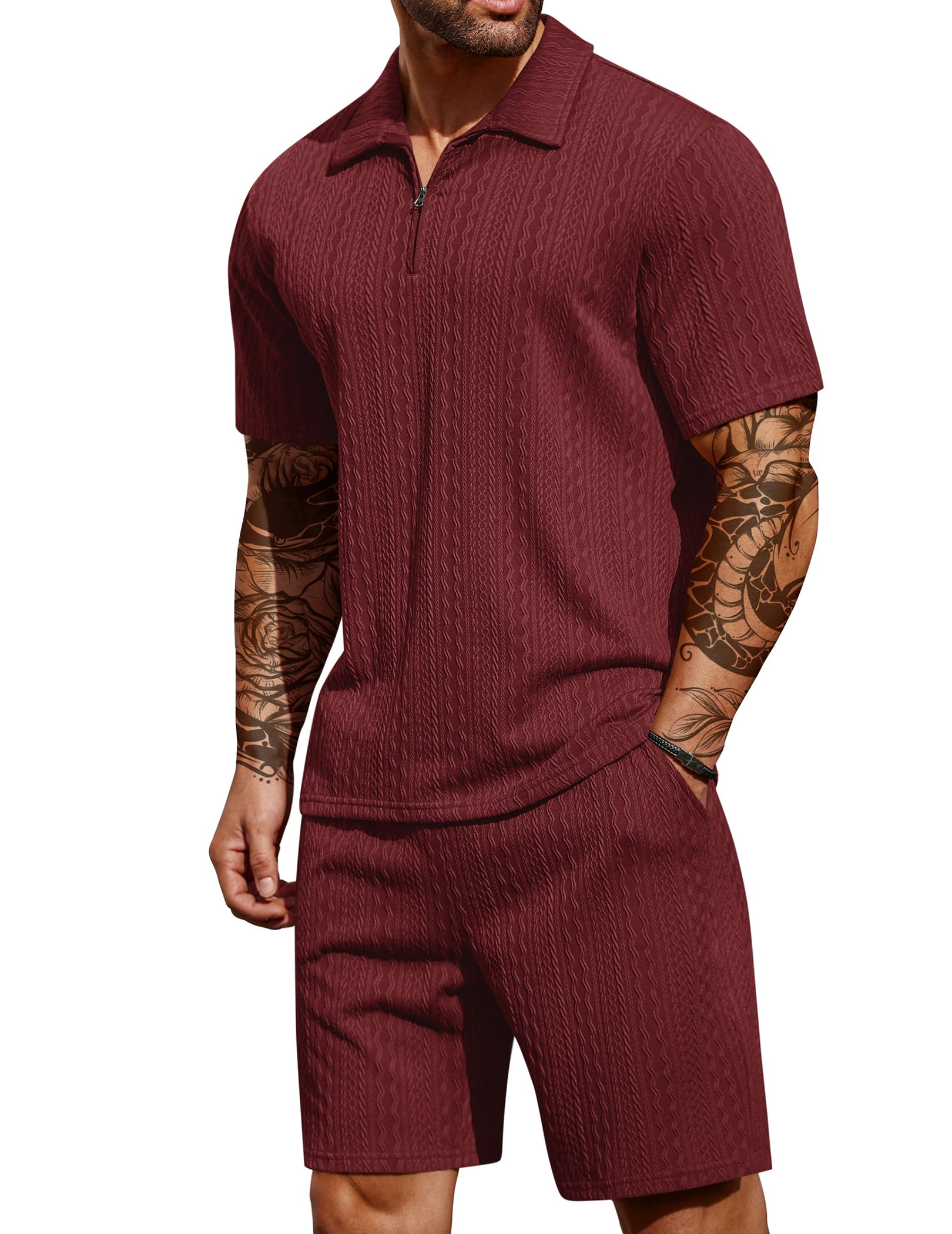 Man wearing a maroon ribbed polo shirt and shorts set on a white background