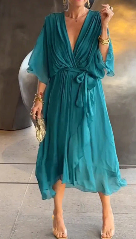 Teal dress worn by a person with a neutral background