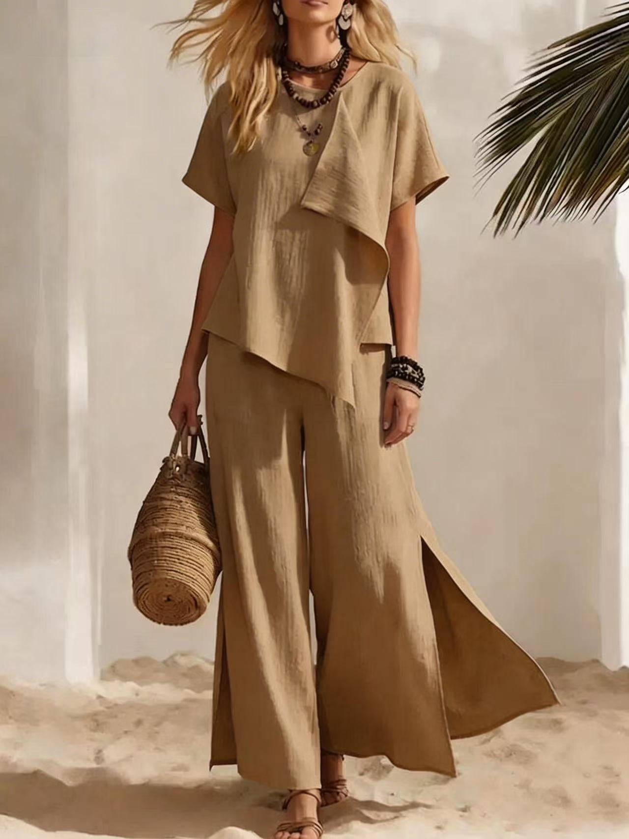 Woman in a beige outfit holding a woven bag on a beach.