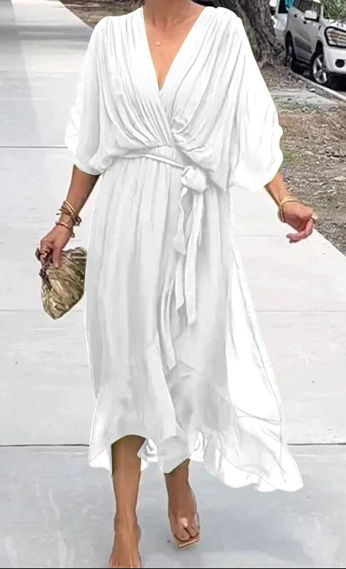 Woman wearing a white dress on a street.
